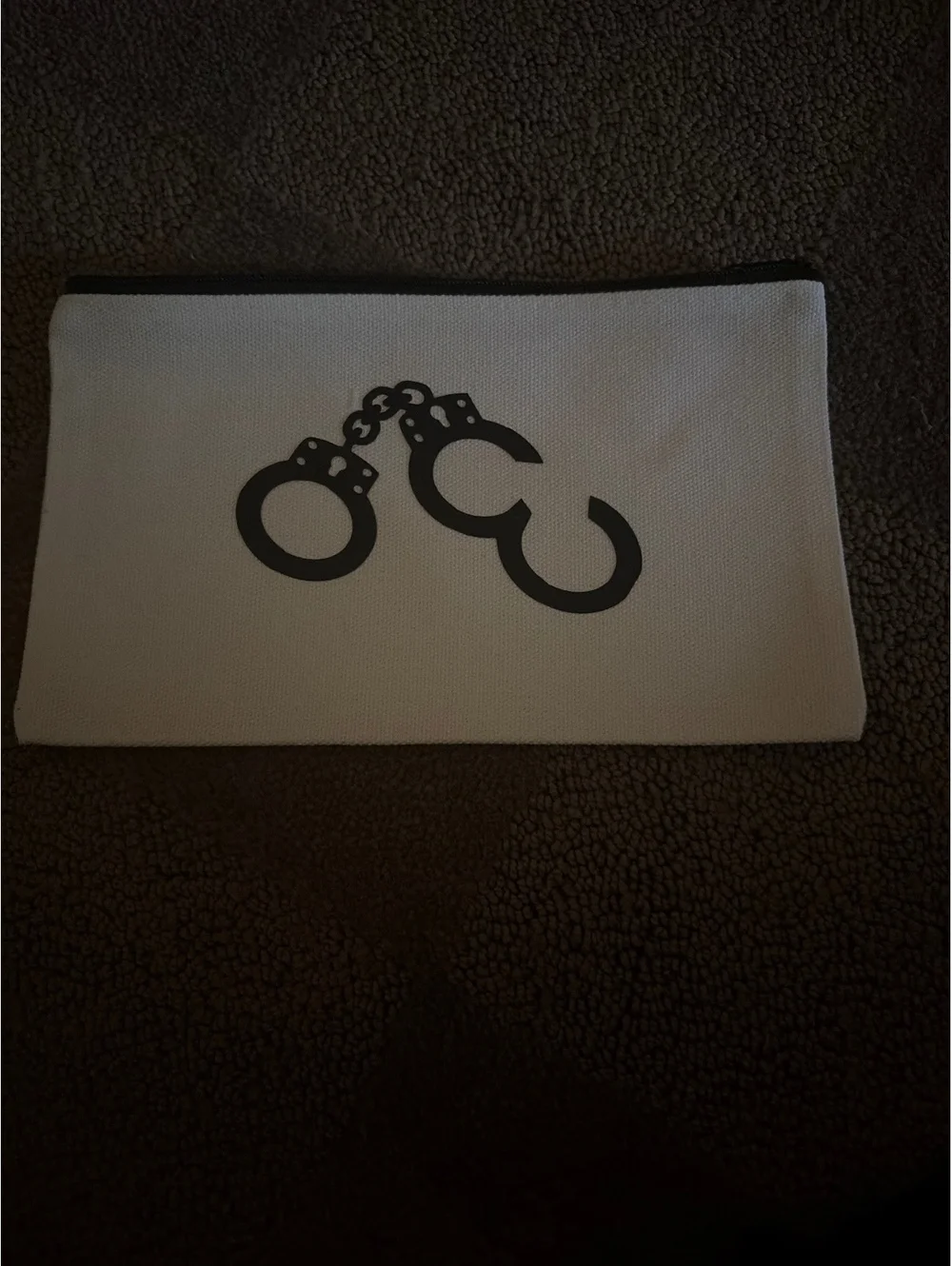 White Canvas Pouch with Black Handcuff Print and Zipper Closure